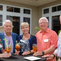Group of guests standing outside at a table at Naples 2019